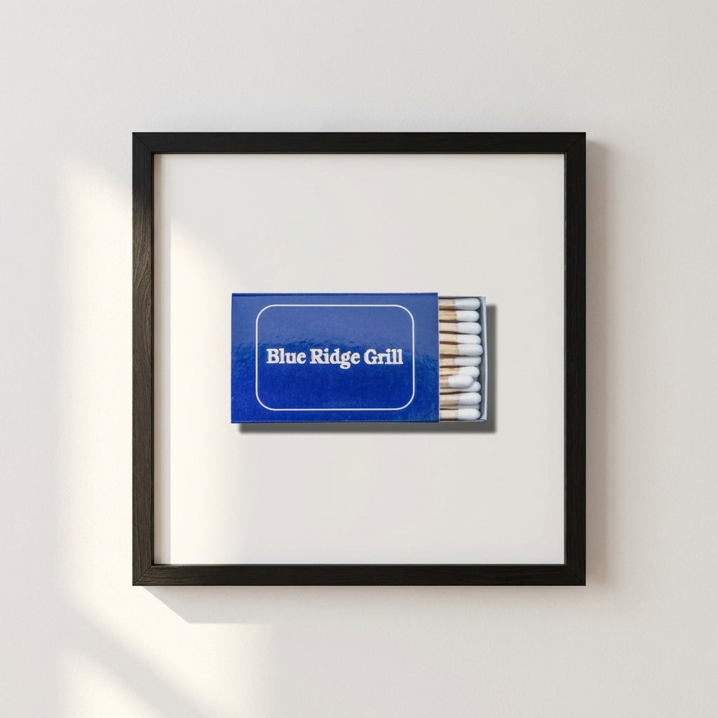 High-resolution image of Blue Ridge Grill framed print mounted on white wall, showcasing natural wood frame and soft lighting.