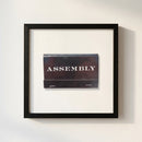 Full-view of Assembly framed print in a warm, inviting environment, emphasizing the textured micro-details of the frame and clarity of the print.