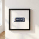 High-resolution image of the Atkins Park Framed Print hanging on a white wall, showcasing its textured matte paper and black wood frame with natural light.