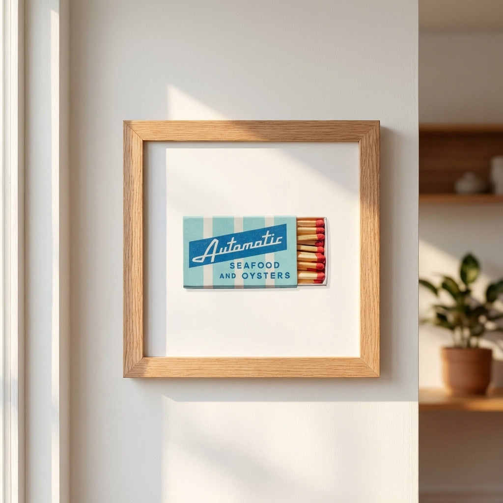 Detailed shot of the 'Automatic Seafood and Oysters' framed poster on a neutral wall, highlighting micro-texture and natural lighting.