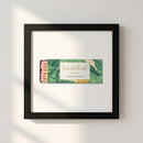 High-resolution image of The Beverly Hills Hotel framed print hanging on a textured white wall in a cozy interior setting.