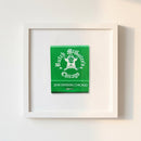 High-quality photograph of a framed 'Butch McGuire’s' print on a white wall, showcasing craftsmanship and natural lighting with textured high-quality paper.