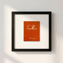 Elegant framed print of Chateau Marmont Hollywood hanging on a white wall with warm natural light, featuring a black wooden frame and textured matte paper.