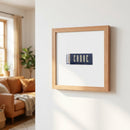 Detailed view of Canoe Atlanta framed poster on white wall, highlighting paper texture, frame details, and reflections on acrylic.