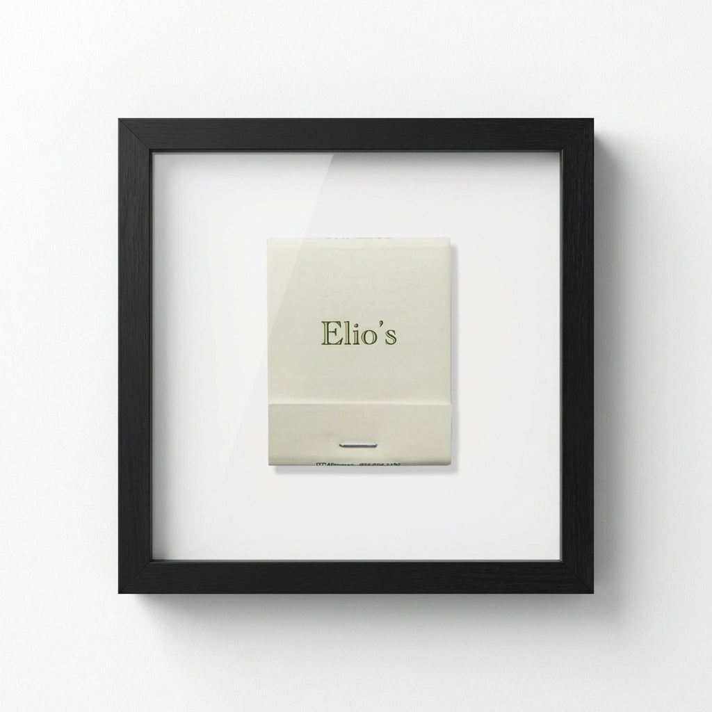 Detailed close-up of Elio’s Framed Print highlighting the textured high-quality paper and elegant wood frame with natural soft lighting.