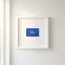 Detailed close-up of Felix framed print showcasing textured paper and wooden frame in warm natural light.
