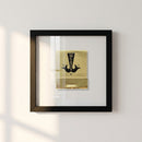 Holywater Framed Print hanging on a wall in a cozy, natural setting with warm lighting, showcasing high-quality print with glossy and matte finish.
