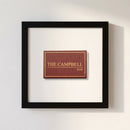 Product shot of Campbell Bar Matchbox framed print on a white wall, illuminated by soft natural warm light in a cozy environment.