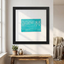 Framed print of The Friend artwork hanging on a white wall in a warm, cozy living room with soft natural lighting.
