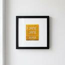Warm, inviting scene of the 'Jane Jane' framed poster hanging on a white wall in a cozy room, showcasing natural sunlight and detailed natural textures.