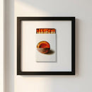 Framed NYC print hanging on a white wall in a cozy, inviting living room with warm natural lighting.