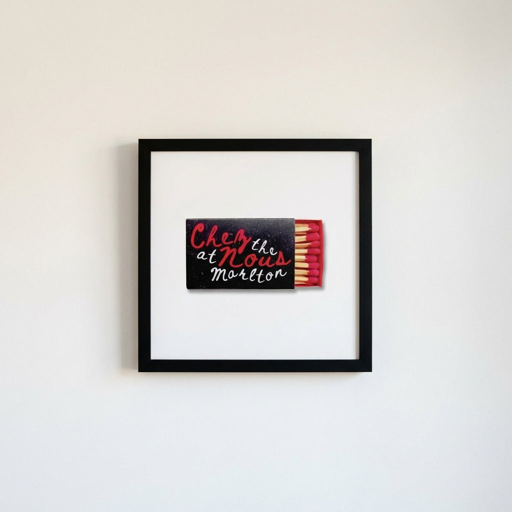 Hyper-realistic image of the 'Chez Nous at The Marlton' framed poster in a clean, minimalist room with soft lighting and subtle micro-texture details.