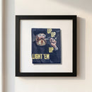 Framed Butcher and Bee print with black wood frame hanging on textured wall in cozy room