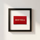 Professional shot of Bottega framed poster hanging on a white wall in a cozy environment, showcasing high-quality paper and wood frame.