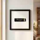 High-resolution Philippe framed print hanging on a white wall, illuminated by natural window light, showcasing glossy and matte textures in a cozy environment.