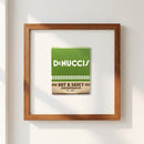 Full view of 'DeNucci’s' framed poster in a warm, inviting environment with natural light, showing micro-texture and color fidelity.