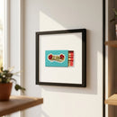 High-resolution image of the El Vez poster framed in ayous wood hanging on a white wall, illuminated by warm natural light, highlighting texture and colors.