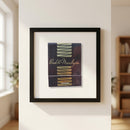 Realistic shot of a 'Bud & Marilyn’s' framed print with acrylic protector in a warmly lit inviting space, showcasing craftsmanship and textured surface.