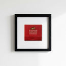 High-resolution shot of Empire Steakhouse framed print on wall, emphasizing black wood frame and detailed textured paper in warm natural light.