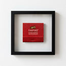 Framed Empire Steakhouse print on white wall, showcasing high-quality paper with glossy and matte finish in cozy living room setting.