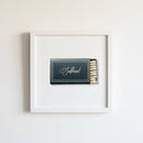 Full view of Southbound framed print centered on white wall in a warm room, showcasing natural lighting, matte paper, and black wooden frame details.