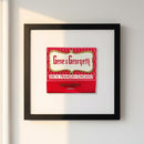 High-resolution framed Gene & Georgetti print on white wall, illuminated by natural window light, showcasing glossy and matte paper finishes with wood texture.