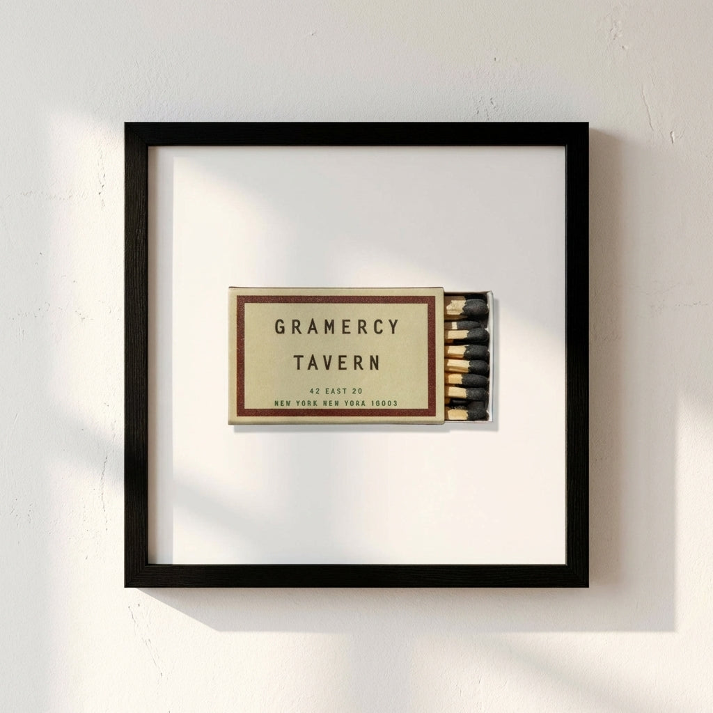 Detailed view of Gramercy Tavern landscape print on white wall, showcasing premium paper and wooden frame in warm daylight.