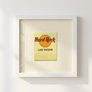 High-resolution image of the Hard Rock Las Vegas framed poster on white wall, showcasing warm natural lighting and detailed wooden frame.