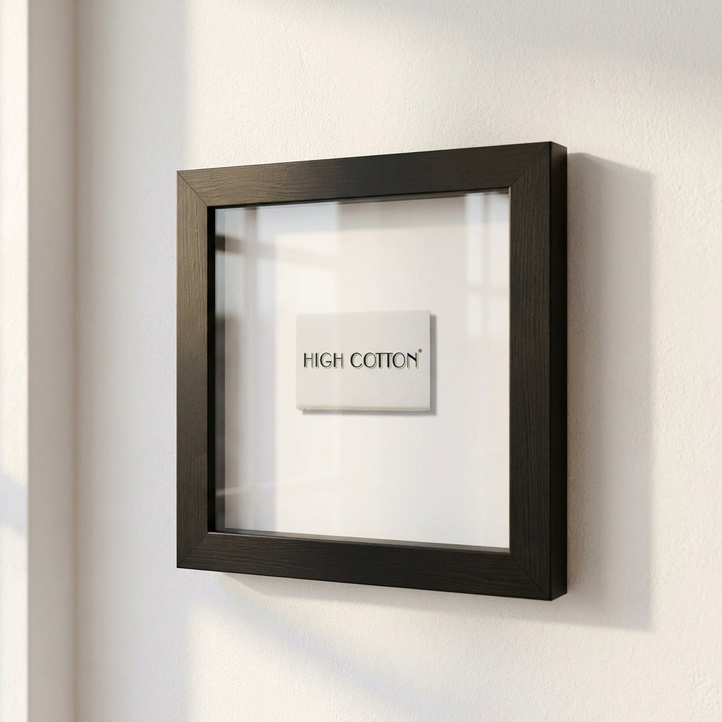 Elegant high cotton framed print on a white wall, highlighted by warm natural light in a cozy, inviting room.