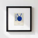 High-resolution image of Perrys framed poster on white wall in a warm, inviting environment with realistic lighting and shadows