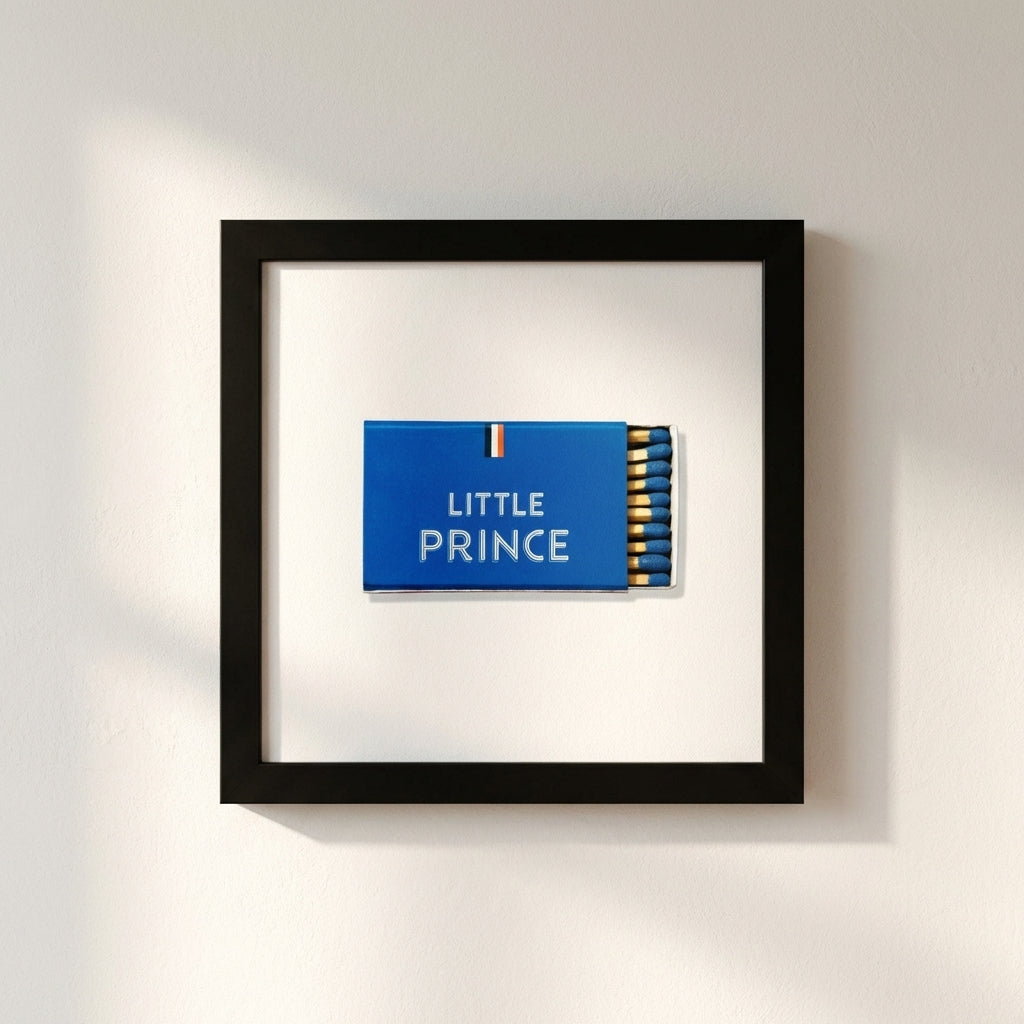 High-resolution shot of Little Prince framed print on white wall, centered, warm soft lighting, detailed textures.