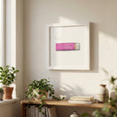 Framed Little Trouble print hanging in a cozy living room with natural light, featuring a textured matte paper and wooden frame.