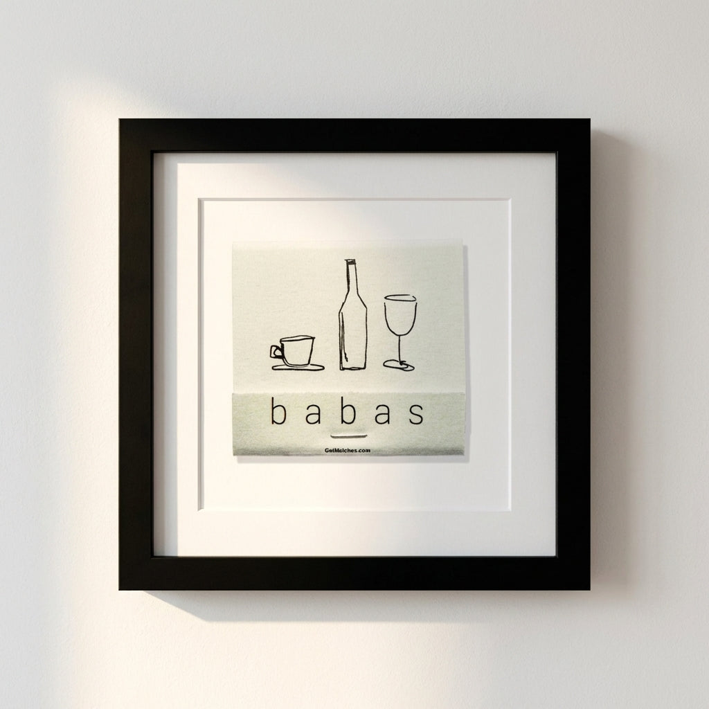 Close-up of 'Babas on Cannon' framed print on white wall in a warm, inviting living room with natural window light.