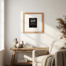 'PB&J's Chicago' framed poster in a natural oak frame displayed on a cozy white wall in a well-lit living room.