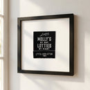 High-resolution photograph of 'Lottie's Chicago' framed print hanging on a wall in a cozy room with natural light, showcasing the textured paper and wooden frame.