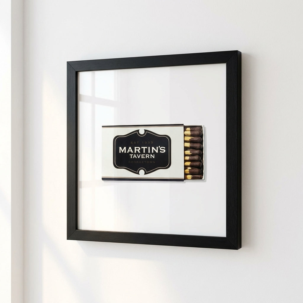 Framed print of Martin's Tavern on a wall, showcasing high-quality paper with glossy and matte finish, wood frame, acrylic protector, in a cozy room.