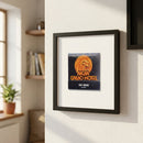 Full view of MGM Grand Hotel framed poster mounted on white wall with natural light highlight and wooden frame.