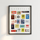 Framed Nashville Matchbox Print poster on a wall, lit with warm natural light in a cozy living room or cafe setting, highlighting detailed textures and warm wood frame.