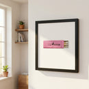 High-quality framed Pink Steak poster hanging on white wall in cozy living room with natural light, showcasing textured glossy and matte paper, white frame, and inviting decor.