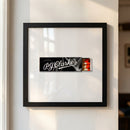 Elegant 10x10 inch framed print of PJ Clarkes displayed on a white wall with natural light, showcasing glossy and matte finishes in a minimalist setting.