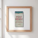 Close-up of Post House Framed Print hanging on a wall, highlighting the black wooden frame and soft shadows in a well-lit room.
