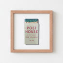 Post House Framed Print in a cozy environment with natural lighting, emphasizing the matte paper, acrylic front, and thick black frame.