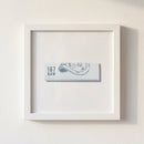 High-quality 167 Raw Framed Print hanging on a white wall with natural warm lighting, showcasing its partly glossy and matte finish.