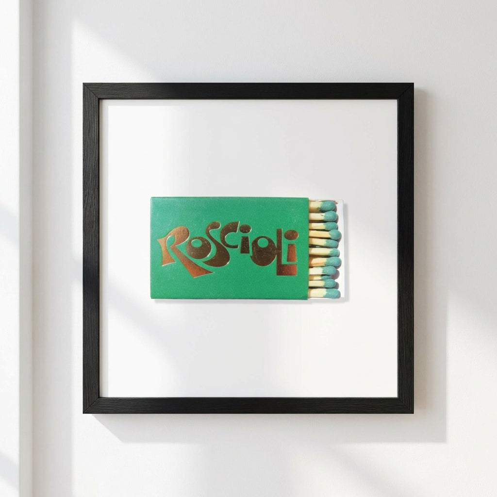 Close-up of the Roscioli NYC framed poster on a white wall, showcasing high-quality paper finish and wooden frame in a cozy setting.