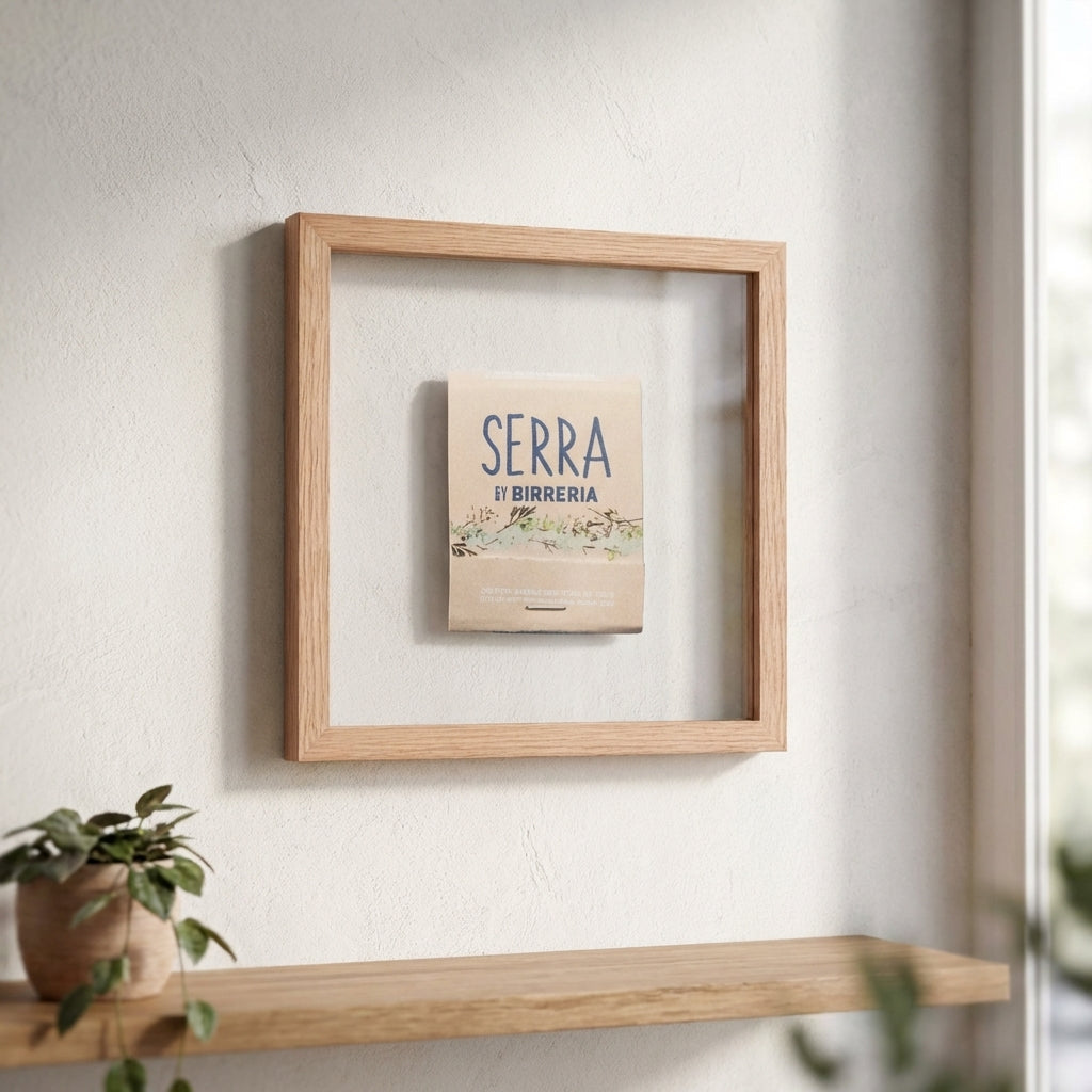 Serra Framed Print displayed in a cozy living room, illuminated by soft natural light, emphasizing its craftsmanship and textured frame.