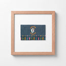 Sharehouse framed print hanging in a cozy living room with warm natural light and sleek matte black Ayous wood frame.
