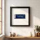 Elegant framed poster of Stella's hanging in a cozy living room lit with warm natural light, showcasing craftsmanship and inviting ambiance.