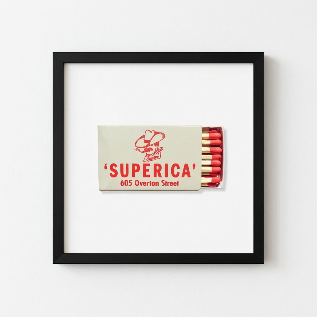Superica framed print hanging against a well-lit wall on plain white background, emphasizing natural wood frame and detailed textures.