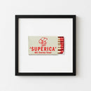 Superica framed print hanging against a well-lit wall on plain white background, emphasizing natural wood frame and detailed textures.