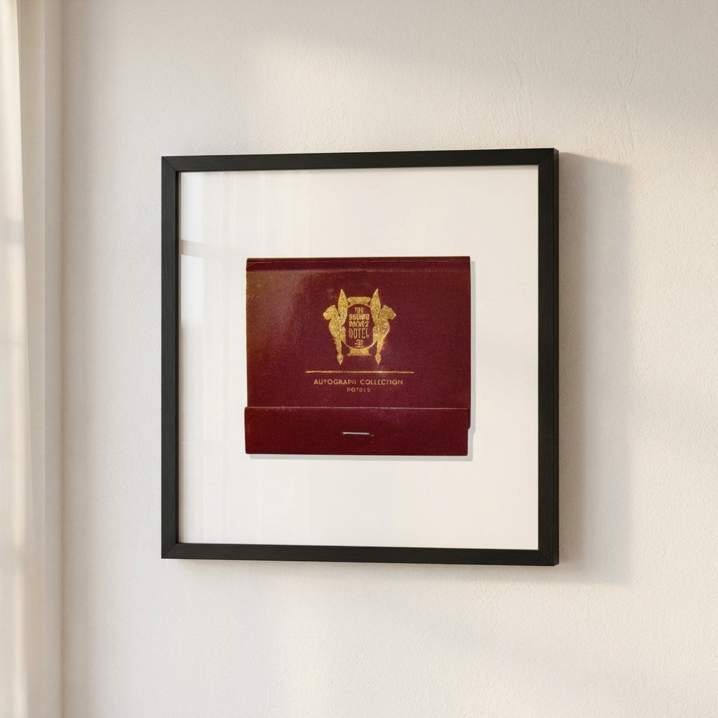 Elegant framed poster of The Brown Palace Hotel hanging on a white wall, with warm lighting and subtle shadows highlighting its high-quality print.